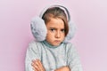 Little beautiful girl wearing fluffy earmuff skeptic and nervous, frowning upset because of problem Royalty Free Stock Photo