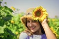 little beauty. small girl in summer sunflower field. happy childrens day. childhood happiness. portrait of happy kid Royalty Free Stock Photo
