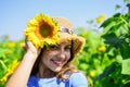 Little beauty. small girl in summer sunflower field. happy childrens day. childhood happiness. portrait of happy kid Royalty Free Stock Photo