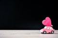 Little beetle pink car carries a heart with love in blank background for text, Valentine`s Day concept, Mother`s Day concept, ma
