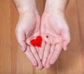 Little and big hearts in male hands Royalty Free Stock Photo