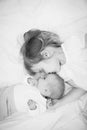 Little big sister lying next to a newborn baby. Royalty Free Stock Photo