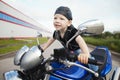 Little biker on road with motorcycle Royalty Free Stock Photo