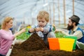 Little biologist. little biologist work with soil. little biologist in greenhouse. little biologist child planting