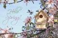 Little birdhouse in spring over blossom cherry tree. Royalty Free Stock Photo