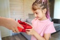 Little birthday girl receiving red giftbox from relatives Royalty Free Stock Photo