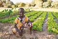 Little Black African Boy Child Smiling in front of Agricultural Camp in Bamako, Mali