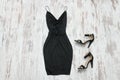 Little black dress and shoes. Wooden background, fashionable con Royalty Free Stock Photo