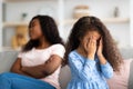 Little black girl crying, having conflict with her angry tired mother at home, free space Royalty Free Stock Photo