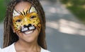 Little black girl with tiger face painting Royalty Free Stock Photo