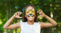 Little black girl with tiger face painting Royalty Free Stock Photo