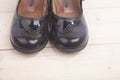 Little black shoes on wooden background