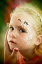 Little blond blue eyed girl face painting Royalty Free Stock Photo