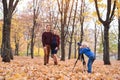 Little blond boy with a big SLR camera on a tripod. Photographs a married couple, pregnancy. Family photo session Royalty Free Stock Photo