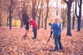 Little blond boy with a big SLR camera on a tripod. Photographs a pregnant mother and son. Family photo session Royalty Free Stock Photo