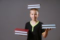 little boy hold the stacks of books in your hands and on your head Royalty Free Stock Photo