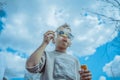 Little Blond Boy Blowing Out Bubbles At Park. Concept of Happy Family And Childhood Royalty Free Stock Photo