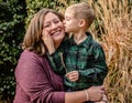 Little blond boy kissing his mother Royalty Free Stock Photo