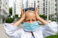 Little blond caucasian girl wearing protective face mask feel stressed and unhappy screaming and crying due quarantine and covid- Royalty Free Stock Photo