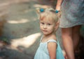 Little blond girl with blue eyes holding her mother`s hand Royalty Free Stock Photo