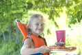 Little blond girl with handmade beach lunch