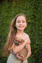 A little blond girl with her pet dog outdooors in park Royalty Free Stock Photo
