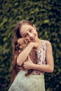 A little blond girl with her pet dog outdooors in park