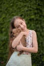 A little blond girl with her pet dog outdooors in park Royalty Free Stock Photo