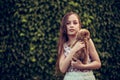 A little blond girl with her pet dog outdooors in park