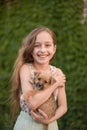 A little blond girl with her pet dog outdooors in park Royalty Free Stock Photo