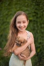 A little blond girl with her pet dog outdooors in park Royalty Free Stock Photo