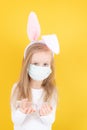 Little blond girl with a medical mask on her face