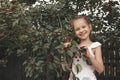 A child in a T-shirt eats ripe cherries from a tree Royalty Free Stock Photo