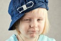 Little blond girl squints eyes Royalty Free Stock Photo