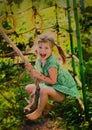 Little blond girl swinging on the cable rope on the summer play Royalty Free Stock Photo