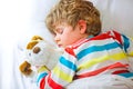 Little blond kid boy in colorful nightwear clothes sleeping Royalty Free Stock Photo