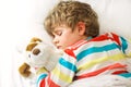 Little blond kid boy in colorful nightwear clothes sleeping Royalty Free Stock Photo