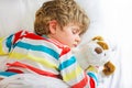 Little blond kid boy in colorful nightwear clothes sleeping Royalty Free Stock Photo