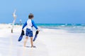 Little blond kid boy having fun on tropical beach of Maldives Royalty Free Stock Photo