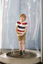 Little blond kid boy playing with huge soap bubbles construction indoors. Happy healthy smiling child having fun with Royalty Free Stock Photo