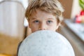 Little blond preschool kid boy with air balloon ball Royalty Free Stock Photo