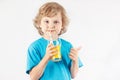 Little blonde boy drinking a fresh orange juice Royalty Free Stock Photo