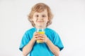 Little blonde child with a glass of fresh orange juice Royalty Free Stock Photo