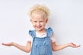 Little blonde confused mistaken kid nice girl 5 years old spreading hands oops gesture Royalty Free Stock Photo