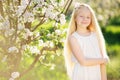 Little blonde girl in blossom garden Royalty Free Stock Photo