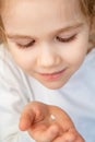 Little blonde girl with fallen milk tooth in hand. Royalty Free Stock Photo