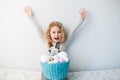 Little blonde girl holding basket with painted eggs. Easter day. Royalty Free Stock Photo