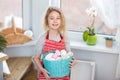 Little blonde girl holding basket with painted eggs. Easter day. Royalty Free Stock Photo