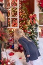 Little blonde girl looking at holiday lights and decorations - v Royalty Free Stock Photo