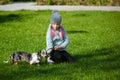 Little blonde girl and a loving puppy dachshund